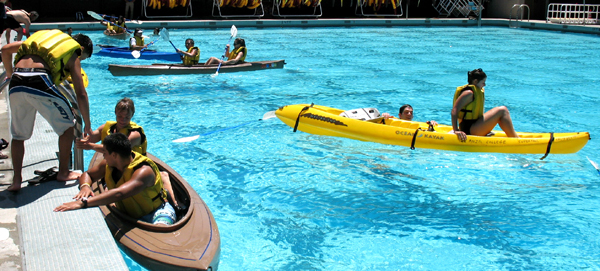 kayak lesson in De Anza college pool 2010: kayakers in and out of the water in an olympic sized pool