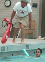 lifeguard Alan Ahlstrand and swimmer with noodle: lifeguard Alan Ahlstrand and swimmer with noodle