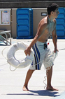 lifeguard Herland Antezana throws a ring buoy photo by Joyce Kuo: lifeguard throws a ring buoy