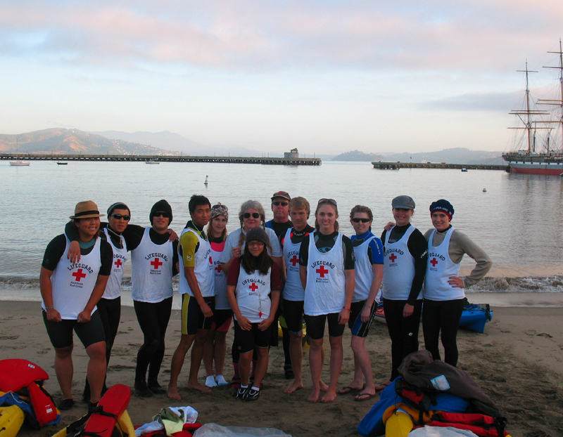 lifeguards group photo Alcatri 2010 photo by Imelda Terrazas: lifeguards lined up on the beach at Aquatic Park with sunrise clouds in background