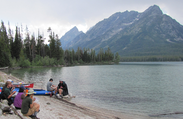 lunch at leigh lake 2011: people sitting on logs and on a kayak at lakeshore