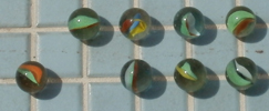 marbles on pool deck: eight marbles on a pool deck