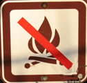no fires symbol: sign with a no fires symbol, a slash through a drawing of a campfire