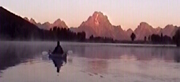 paddler and pink sunrise grand tetons: 