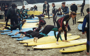 surfing practice: We practice standing up on boards on the beach before we go out.