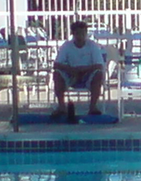 private pool Cupertino lifeguard July 2009 not rescue ready: a lifeguard is not rescue ready, sitting with his rescue tube at his feet as a footrest