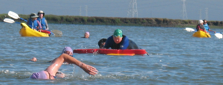 2009 Senior Games triathlon lifeguards Peter Ye, Sherry Fong, Ted Beckman, April Sanchez and Susan Restani: 2009 Senior Games triathlon lifeguards: Peter Ye doing a rescue on a board, Sherry Fong, Ted Beckman, April Sanchez and Susan Restani in kayaks.