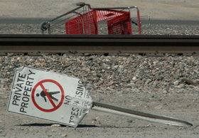 sign no trespass, rr tracks, shopping cart.: 