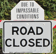 sign road closed due to impassable conditions: sign that says road closed due to impassable conditions