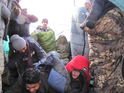 starting to settle down for group photo: starting to settle down for group photo crowded in a tent