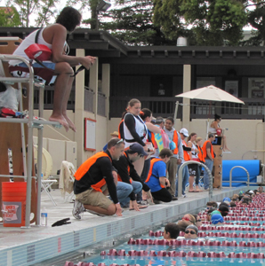 svkt 2011 just before a wave start: volunteers and lifeguards on deck talk to swimmers in water just before the start of one of the races at a kids triathlon