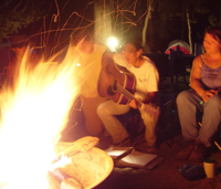 playing guitar by the campfire: 
