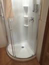 shower in a corner with glass door