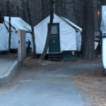 canvas tent cabins and a restroom building
