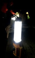 a water bottle on top of a large flashlight