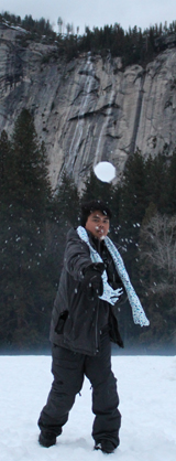 man throwing a snowball with the snowball in mid-air