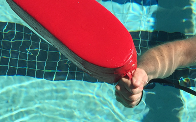 a hand at the end of a rescue tube line next to the end of the rescue tube
