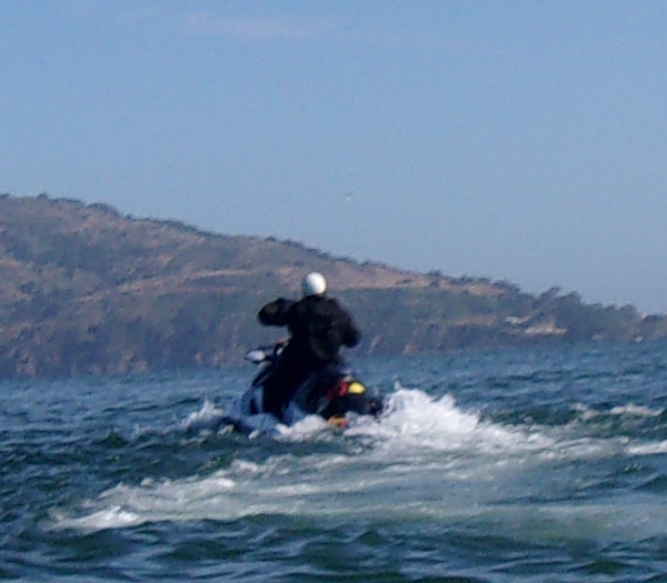 officer with white helmet on watercraft