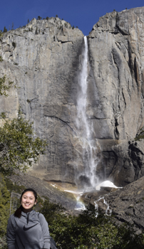 woman on trail with upper Yosemite Falls in background