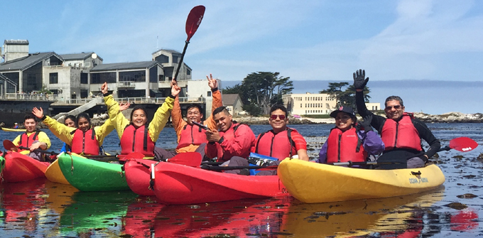 kayakers in front of Monterey Bay Aquarium