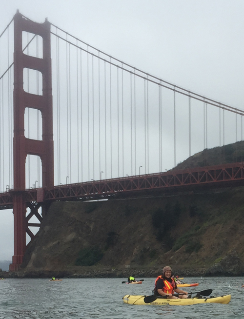 girl in kayak with Golden Gate bridge behind her
