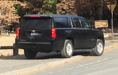 SUV moving off bike path, one tire down on roadway