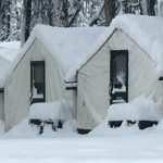 snow covered tent cabins