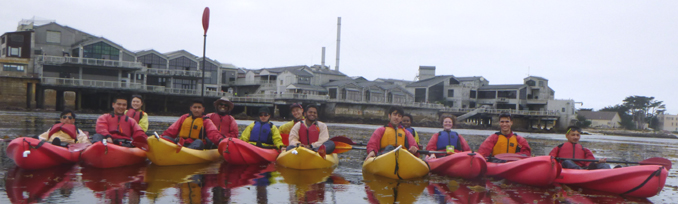 13 students in kayaks in a row