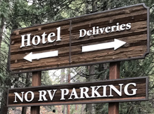 sign with arrows that says hotel and deliveries
