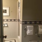 bathroom with tiled walls, stall shower and tub
