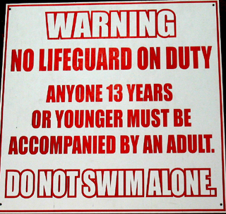 sign says warning no lifeguard on duty