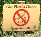 sign says give plants a chance please stay off