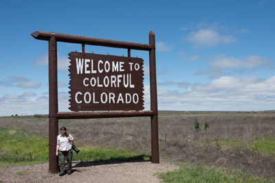 woman next to roadside sign