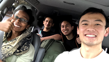 four smiling carpoolers