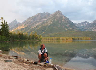 man sitting by lake