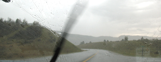 wiper blade on windshield with huge raindrop splatters