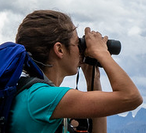 woman looking through binoculars