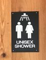 sign says unisex shower