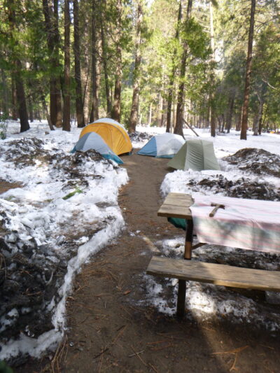 space cleared in snow with tents pitched