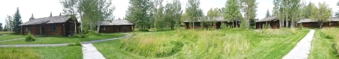 cabins surrounding a meadow