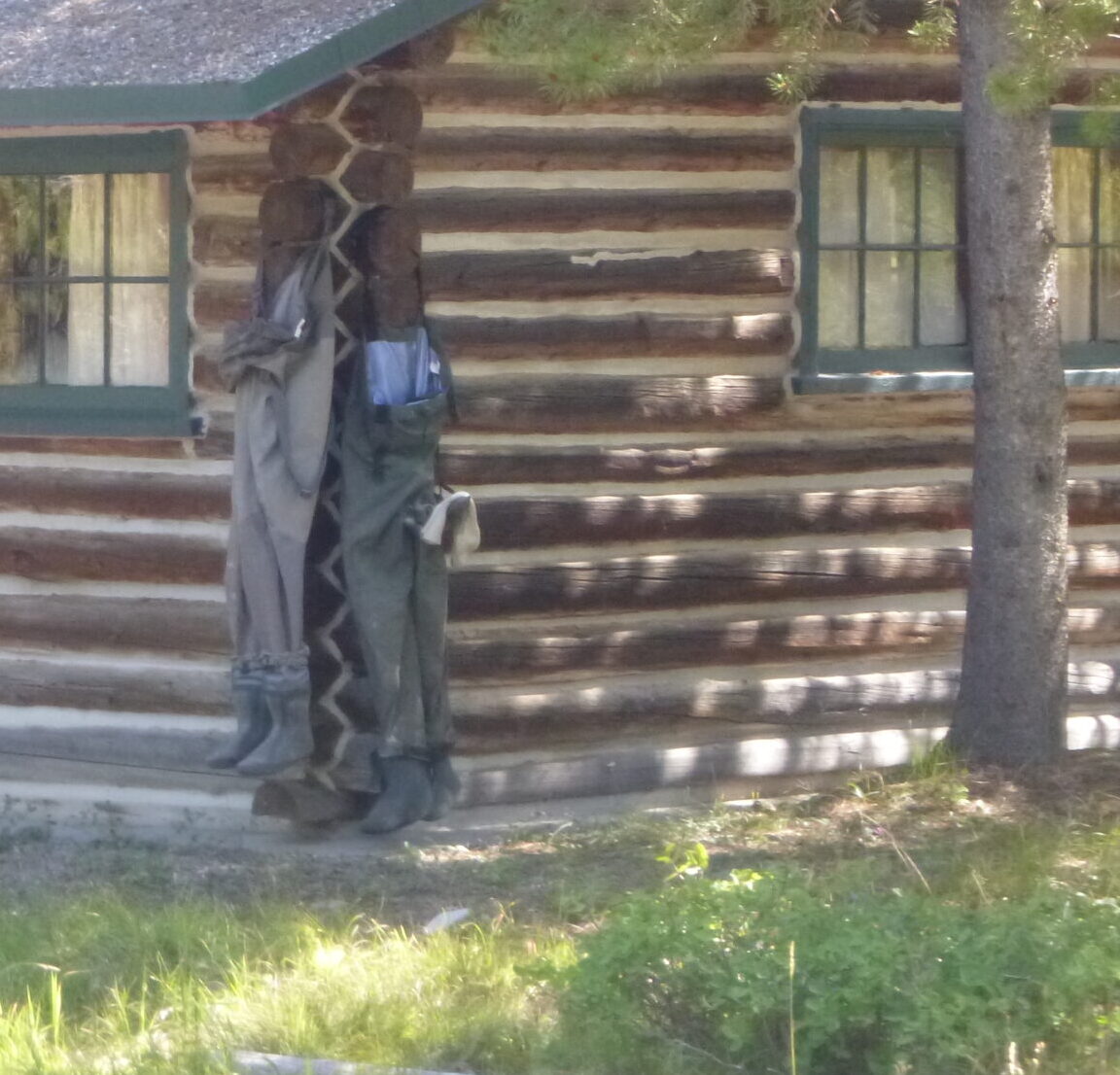 waders hanging to dry on outside of cabin