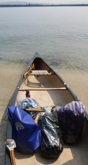 canoe at lake edge with dry bags