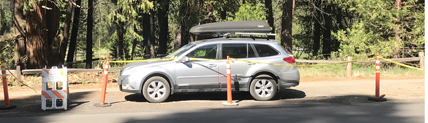 suv parked behind no parking barrier