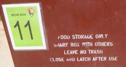 sign on bear box says food storage only, share with others, leave no trash, close and latch after use