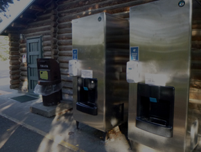 large trash bin and two ice machines