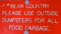 sign says bear country please use outside dumpsters for all food garbage