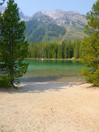 wide sandy beach, lake and mountains