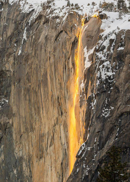 waterfall lit by sunset light