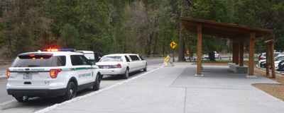 Ranger vehicle with lights flashing, limo in front of it