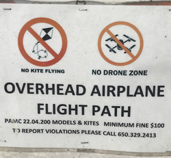 sign about overhead airplane flight path